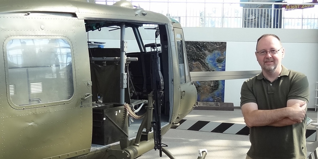 Chris beside a Huey